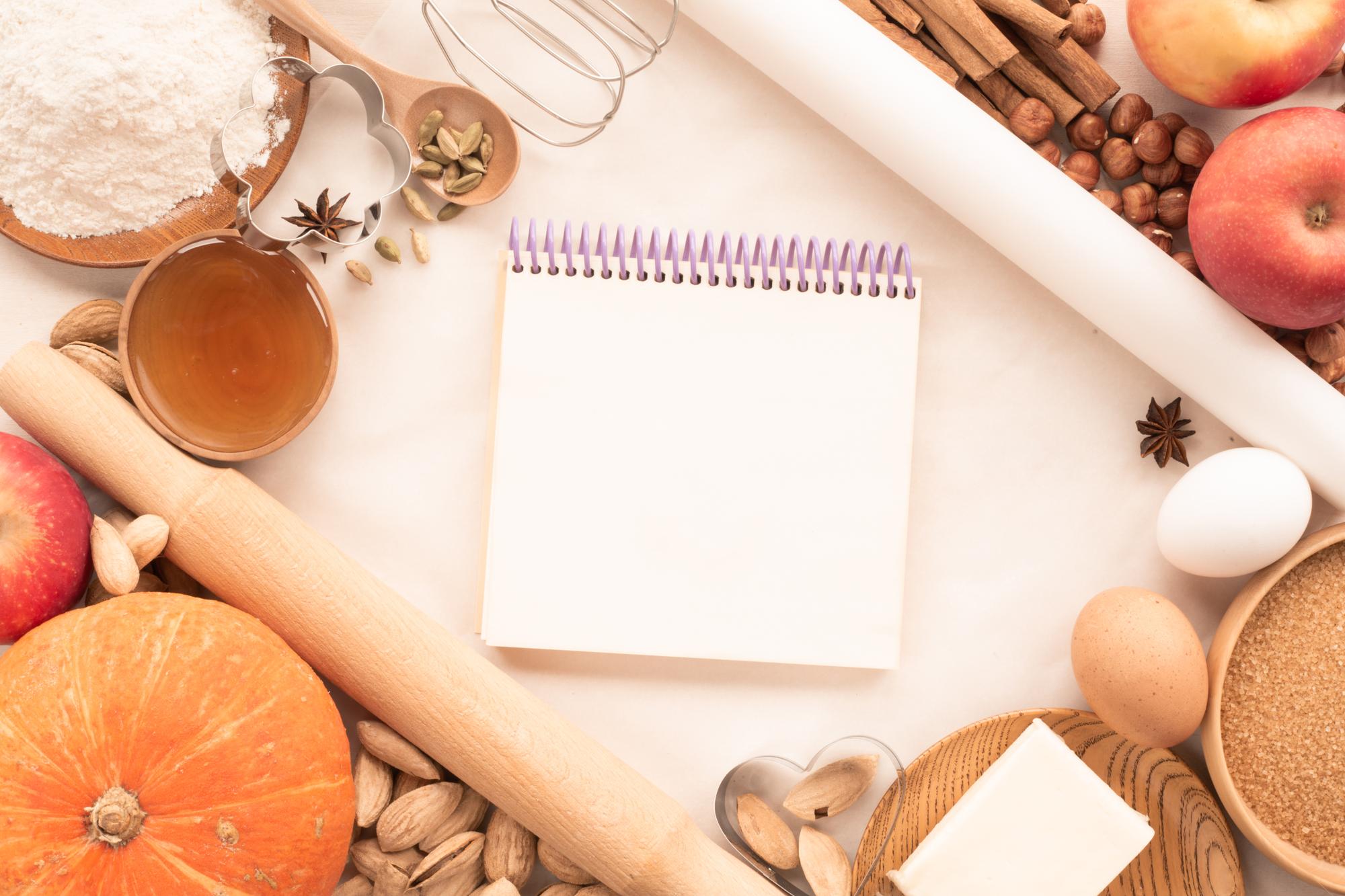 Cozy kitchen table with ingredients and notebook