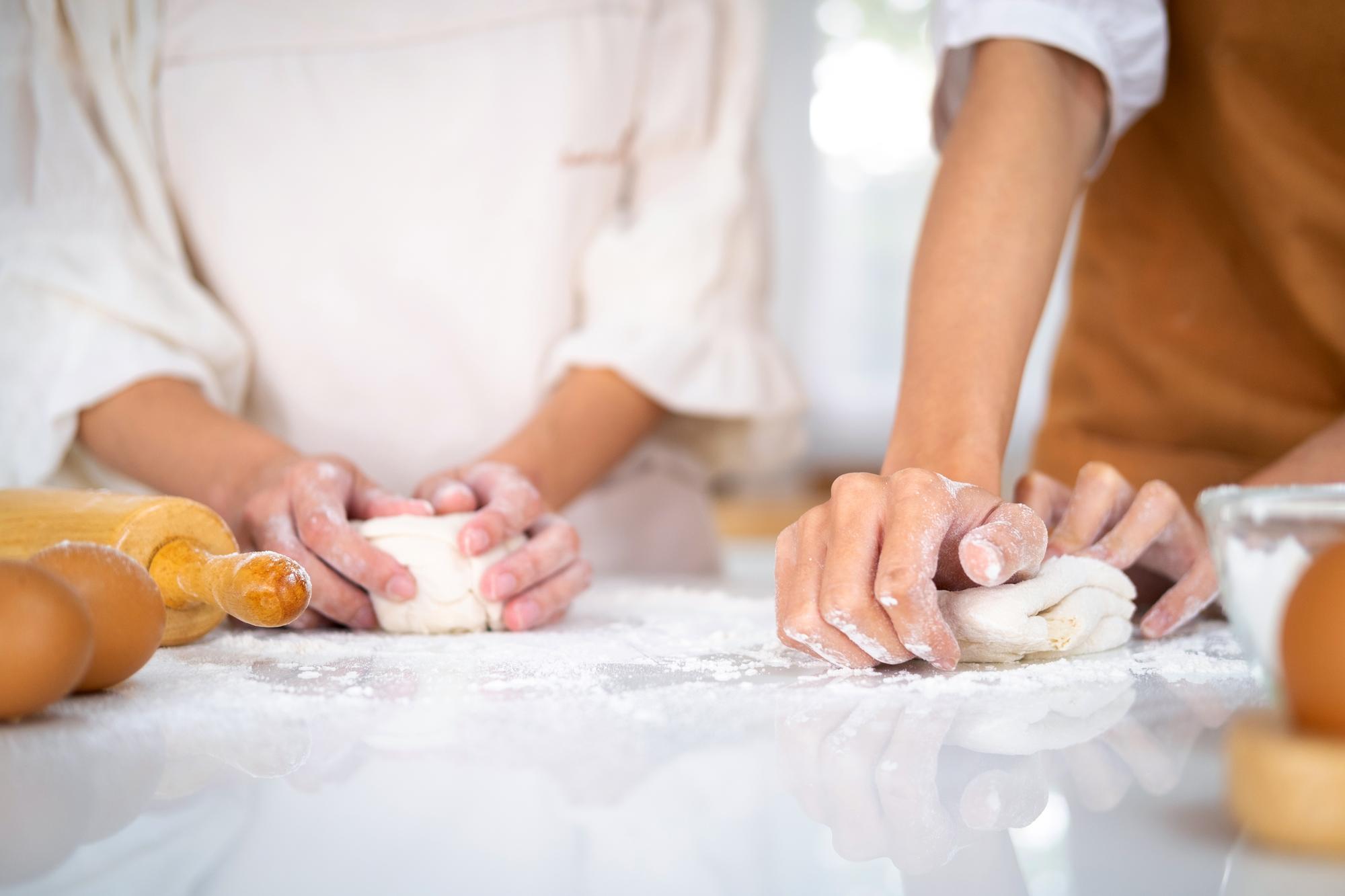 Student kneading dough in workshop